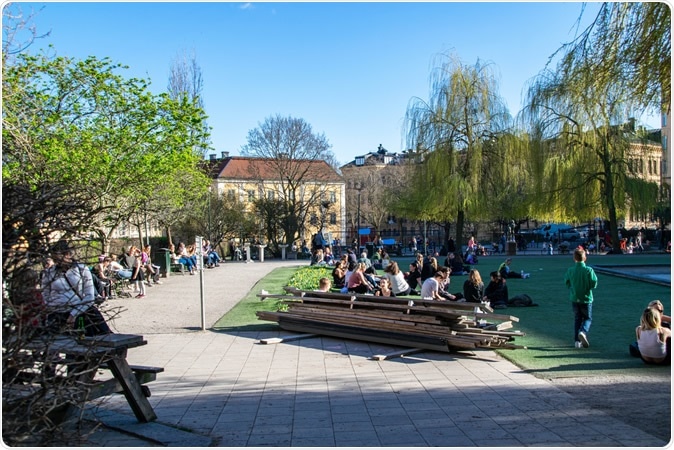 Stockholm / Sweden - April 21, 2020: Swedes outdoors enjoying spring weather during coronavirus pandemic, at a popular square called