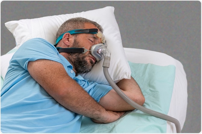 Man with sleeping apnea and CPAP machine. Image Credit: JPC-PROD / Shutterstock