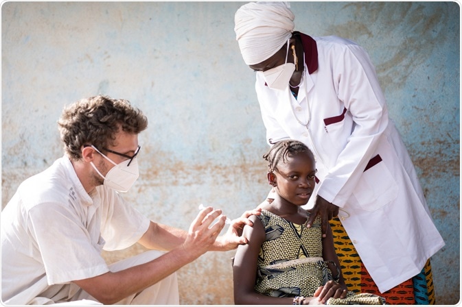 Doctor giving young child a vaccine