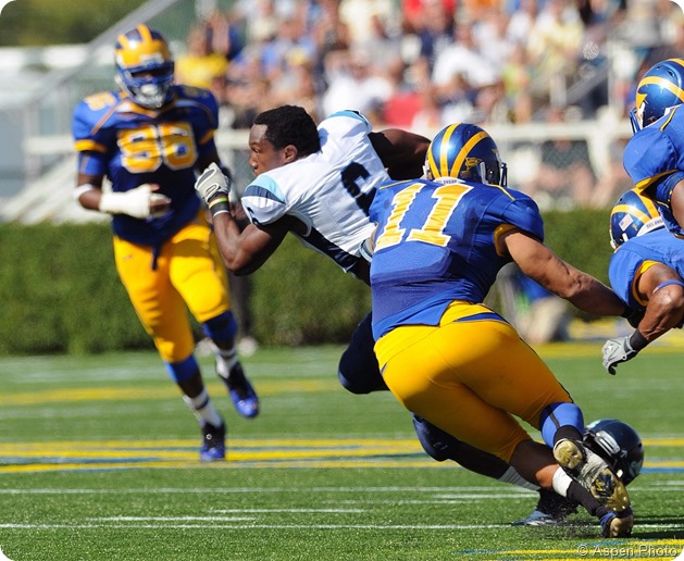 NEWARK, DE - OCTOBER 9 University of Maine running back Derrick Session (#6) runs away from defenders with the ball and without his helmet October 9, 2010 in Newark, DE