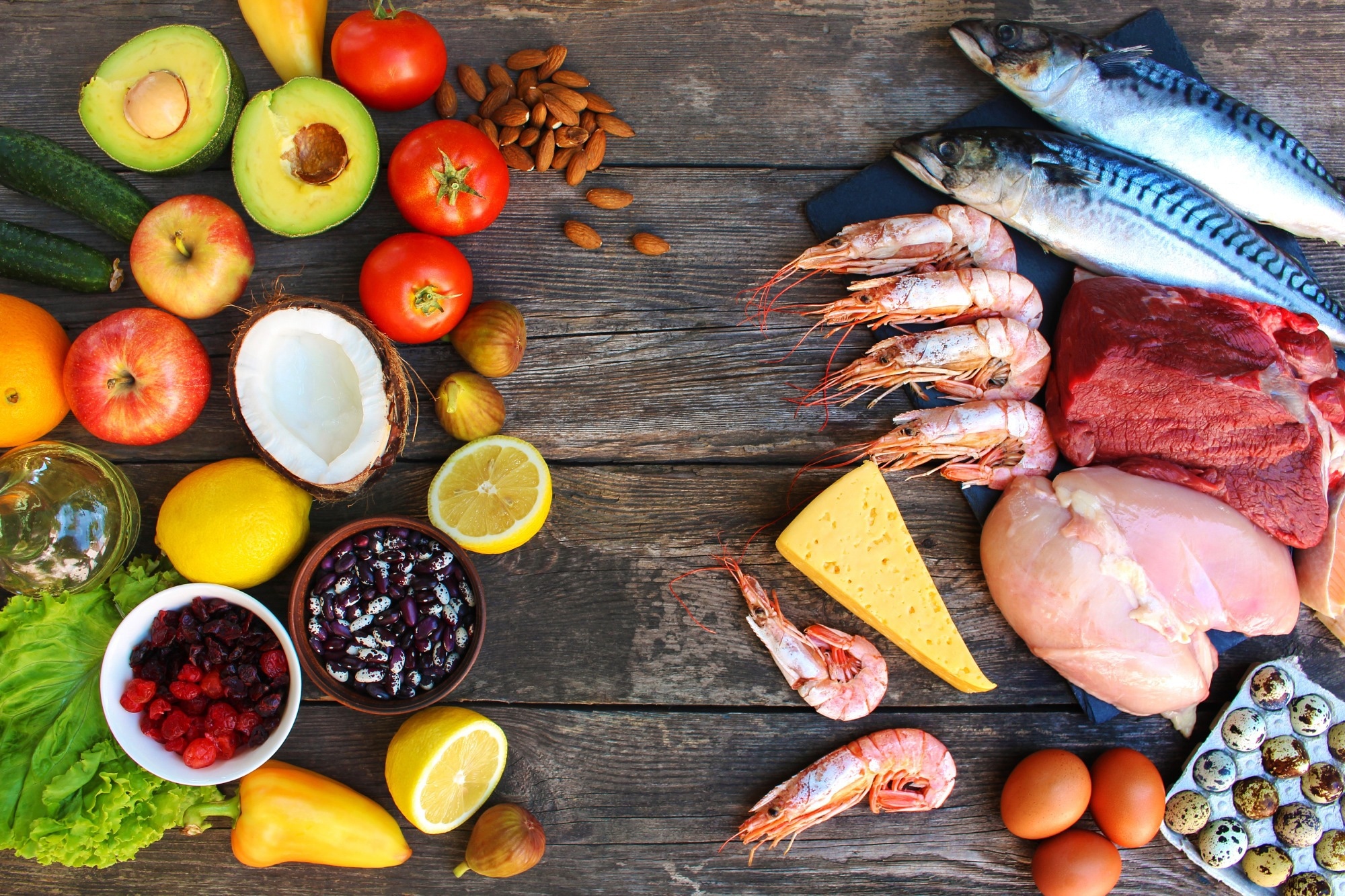 Healthy food of animal and vegetable origin on old wooden background.