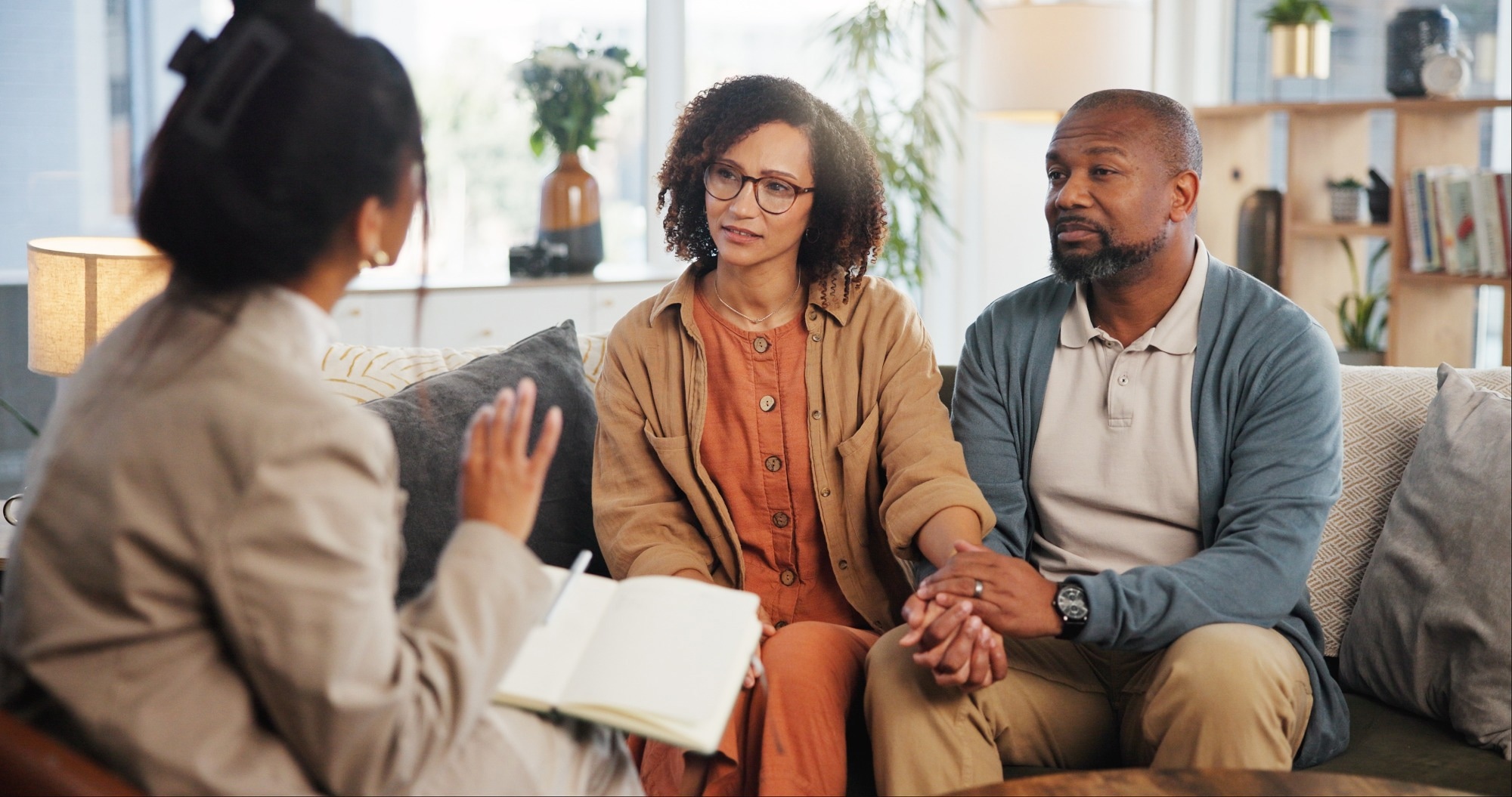 Couple holding hand on therapy couch together