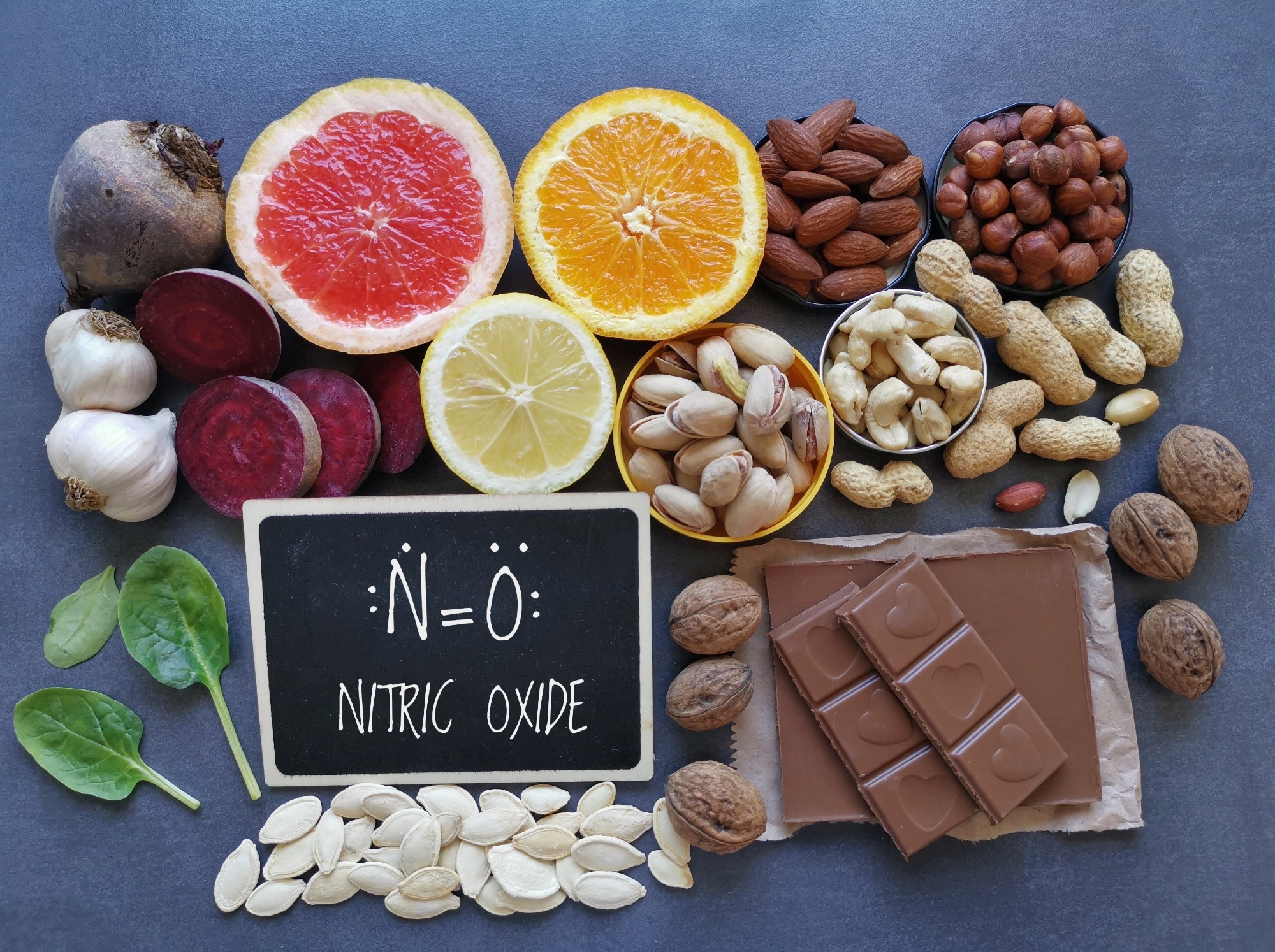 Foods to increase nitric oxide level. Nitric oxide boosting superfood for optimal health. Nitric oxide rich food with chemical formula of nitric oxide. Fruit and vegetable high in nitrates such as oranges, beetroot and almonds.